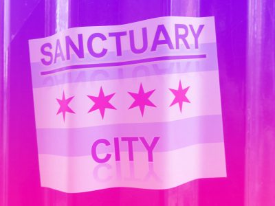 Sanctuary City written on a Chicago flag